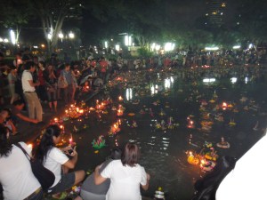 Loy Krathongs lit with candles floating on the lake