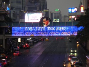 Lighted "Long Live the King" banner on a skywalk across a city street