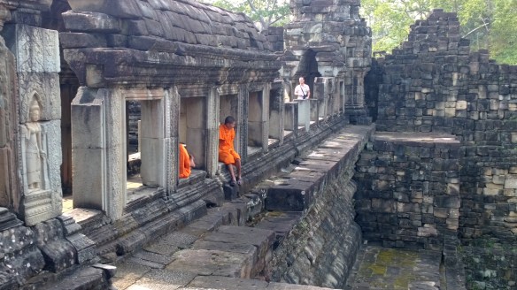 Monks in saffron robes at Baphuon Temple