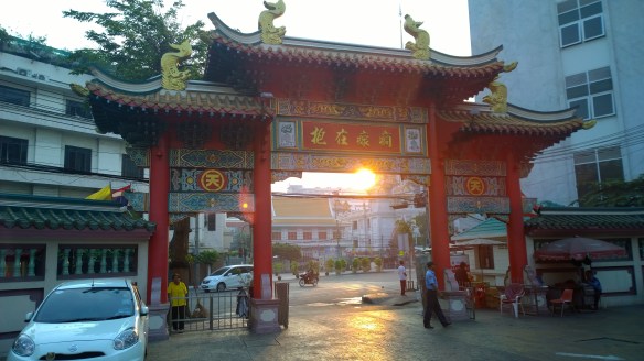 Gate to the Chinese temple, with the sunrise behind it
