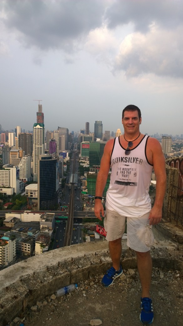 Me at the top and edge of the building, very sweaty after climbing 50 floors