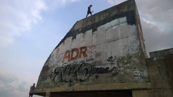 Someone climbing to the very, very top of the building, on what would have been the dome on the top